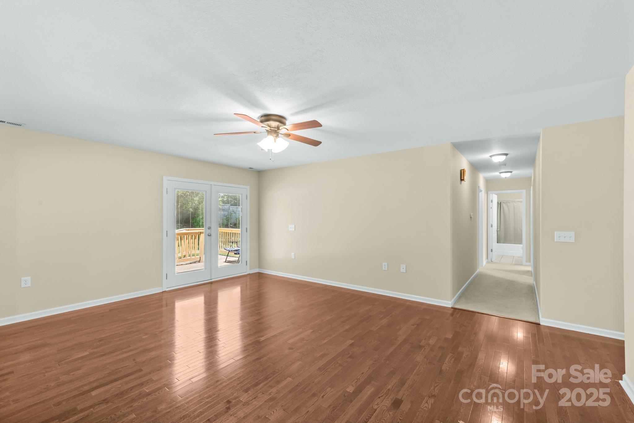 2133 Olde Farm Road Southeast Hudson, NC 28638 - Photo 7 of 42 a view of an empty room with wooden floor and a window