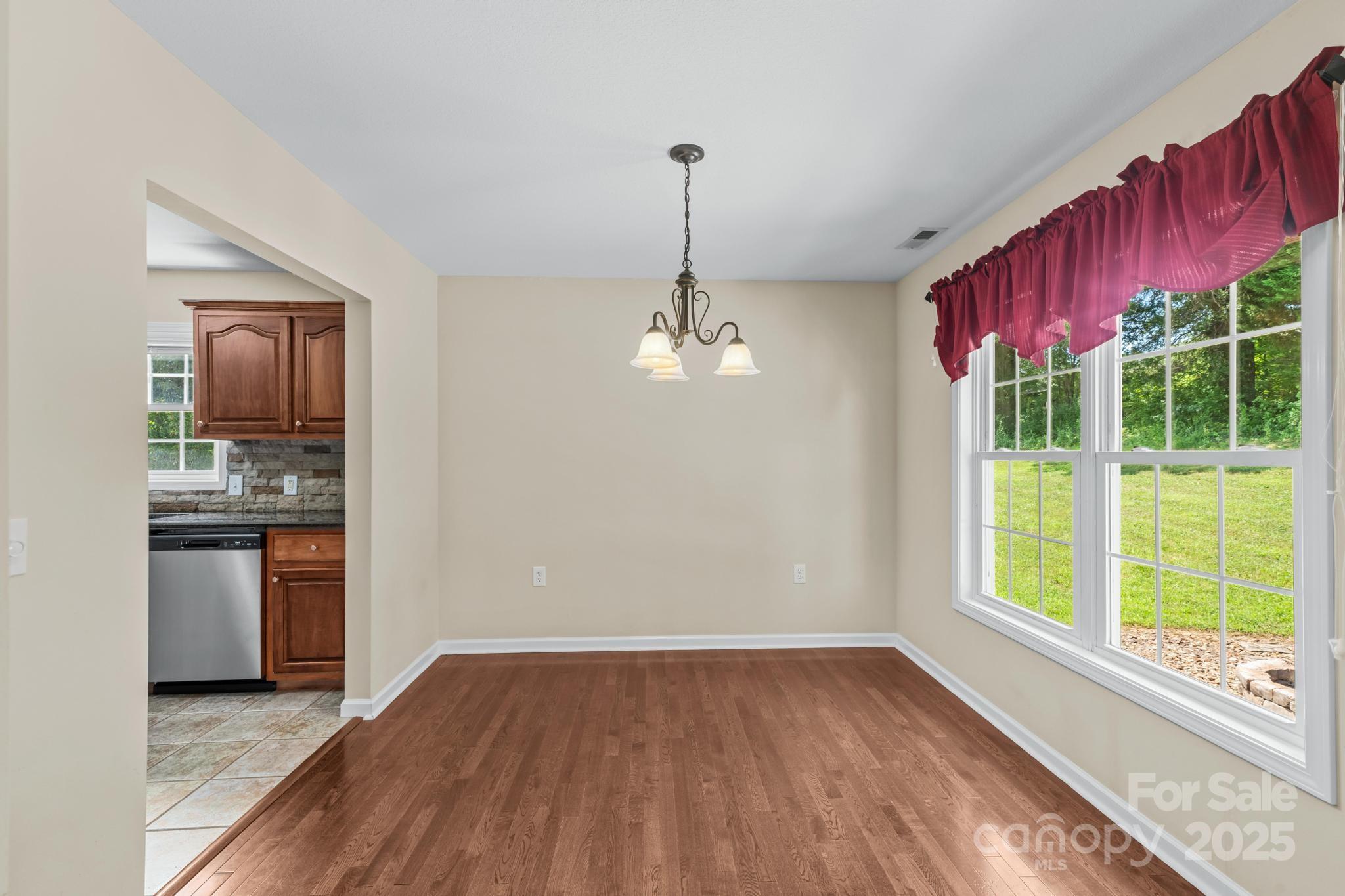 2133 Olde Farm Road Southeast Hudson, NC 28638 - Photo 9 of 42 a view of a kitchen with a sink and dishwasher with wooden floor