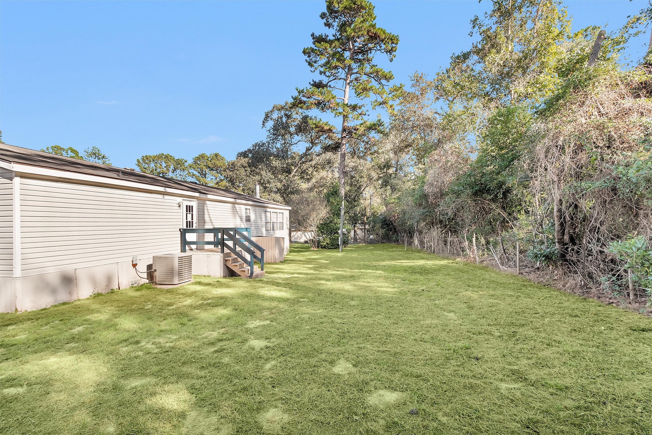 11261 Rose Road Conroe, TX 77303 - Photo 28 of 30 a house with trees in the background