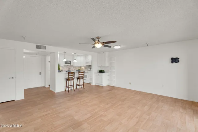 a view of a kitchen counter space with stainless steel appliances granite countertop furniture and a large window