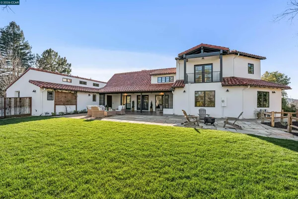 a view of a house with swimming pool and sitting area