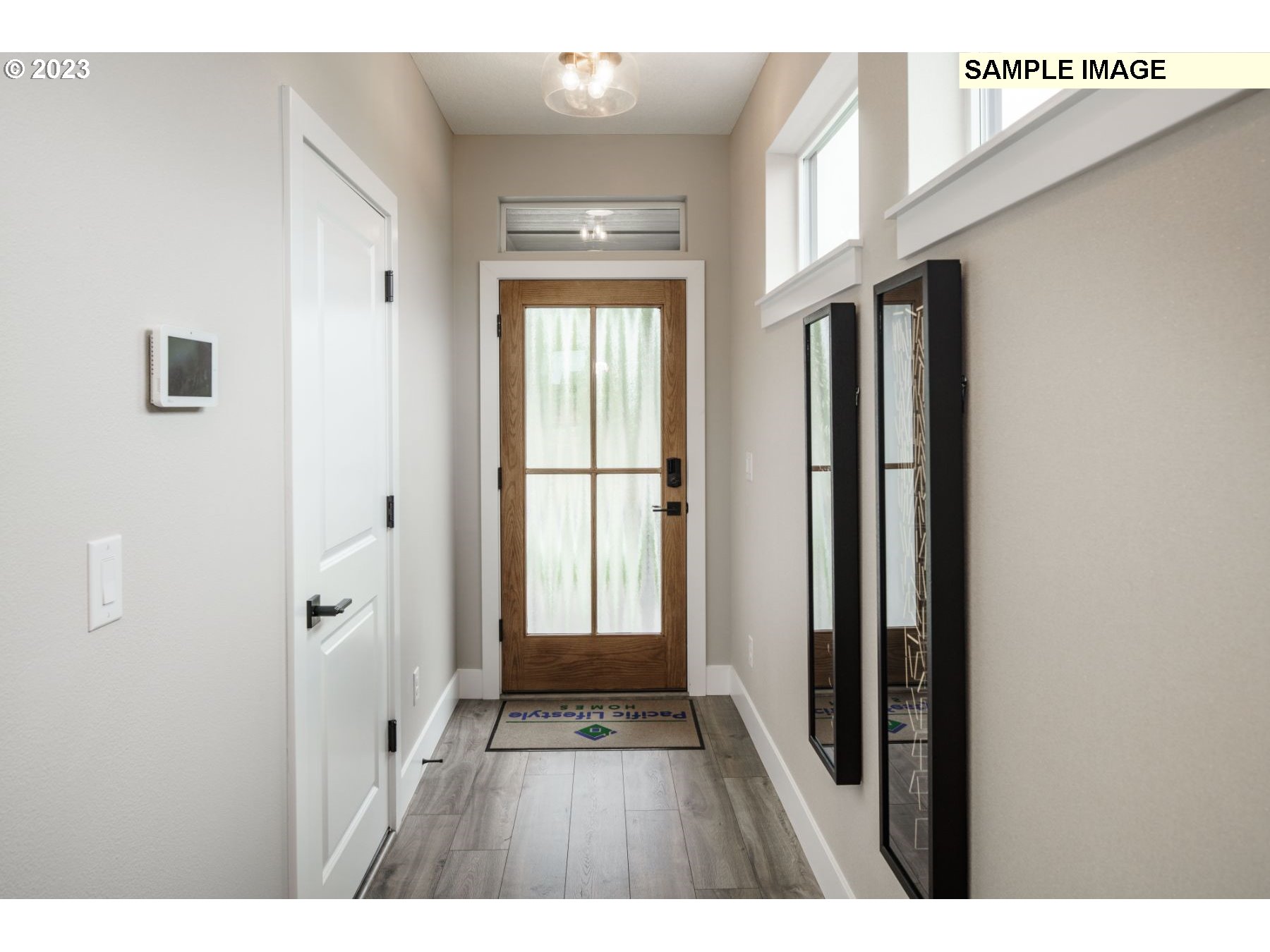 17801 Northwest 7th Avenue, Unit 76 Ridgefield, WA 98642 - Photo 3 of 20 a view of a hallway with wooden floor and staircase