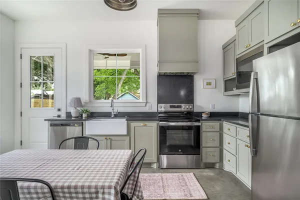 a kitchen with a stove a refrigerator and a sink