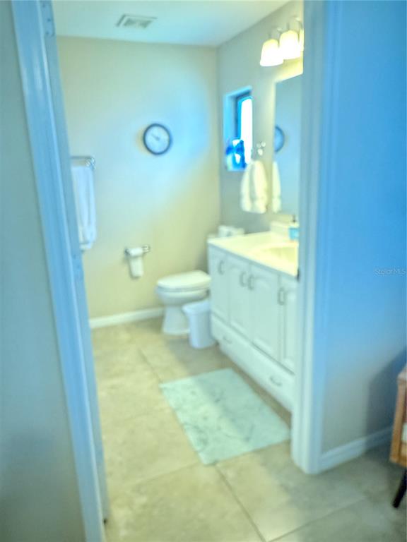 3601 Magnolia Way Punta Gorda, FL 33950 - Photo 11 of 26 a bathroom with a toilet sink and mirror