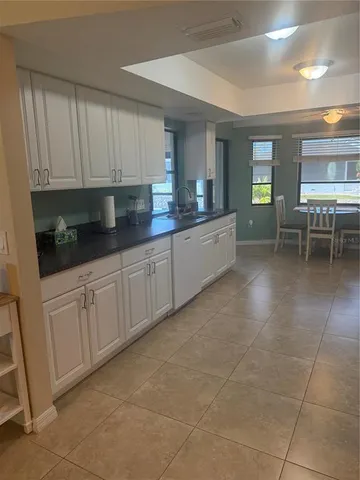 a white refrigerator freezer sitting inside of a kitchen
