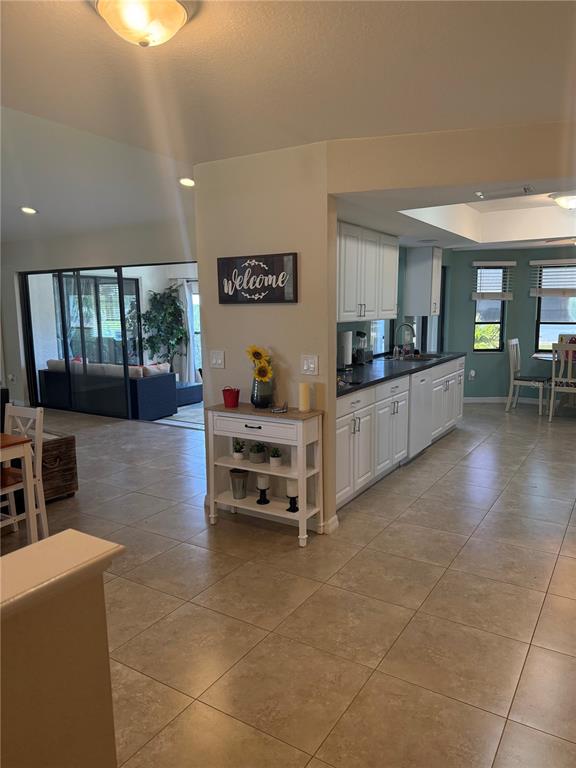 3601 Magnolia Way Punta Gorda, FL 33950 - Photo 2 of 26 a kitchen with stainless steel appliances a stove a sink a oven a dining table and chairs
