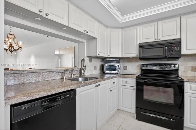 a kitchen with stainless steel appliances granite countertop a stove microwave and cabinets