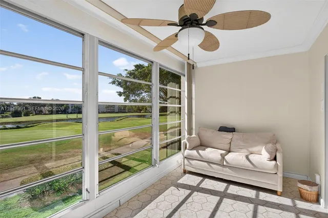 a bedroom with furniture and a large window