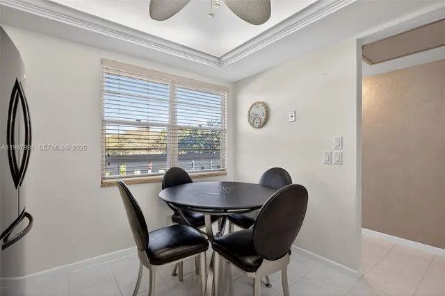 a dining room with furniture and window