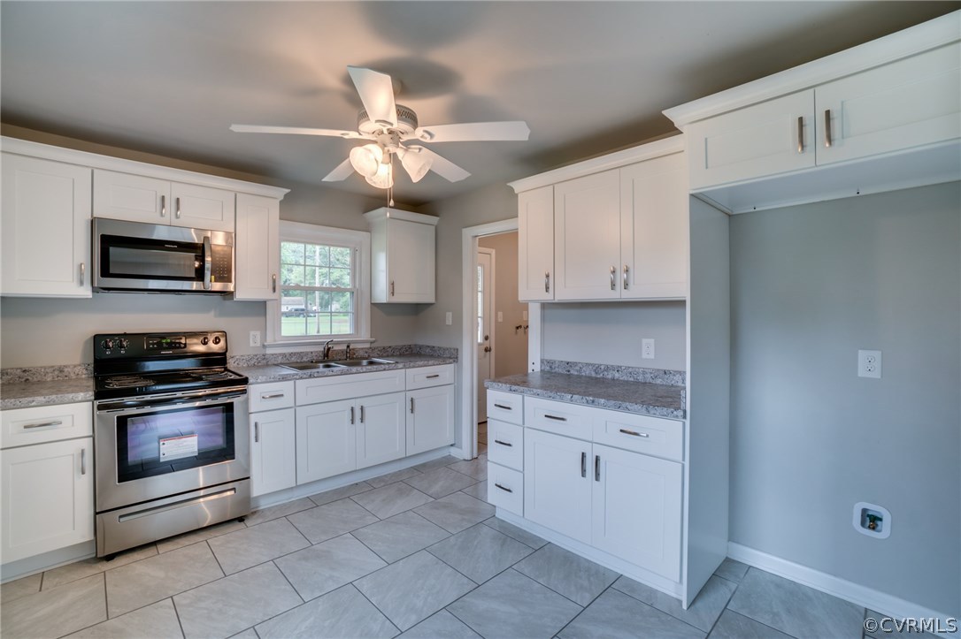 5525 Jahnke Road Richmond, VA 23225 - Photo 20 of 35 a kitchen with granite countertop cabinets stainless steel appliances and a counter space