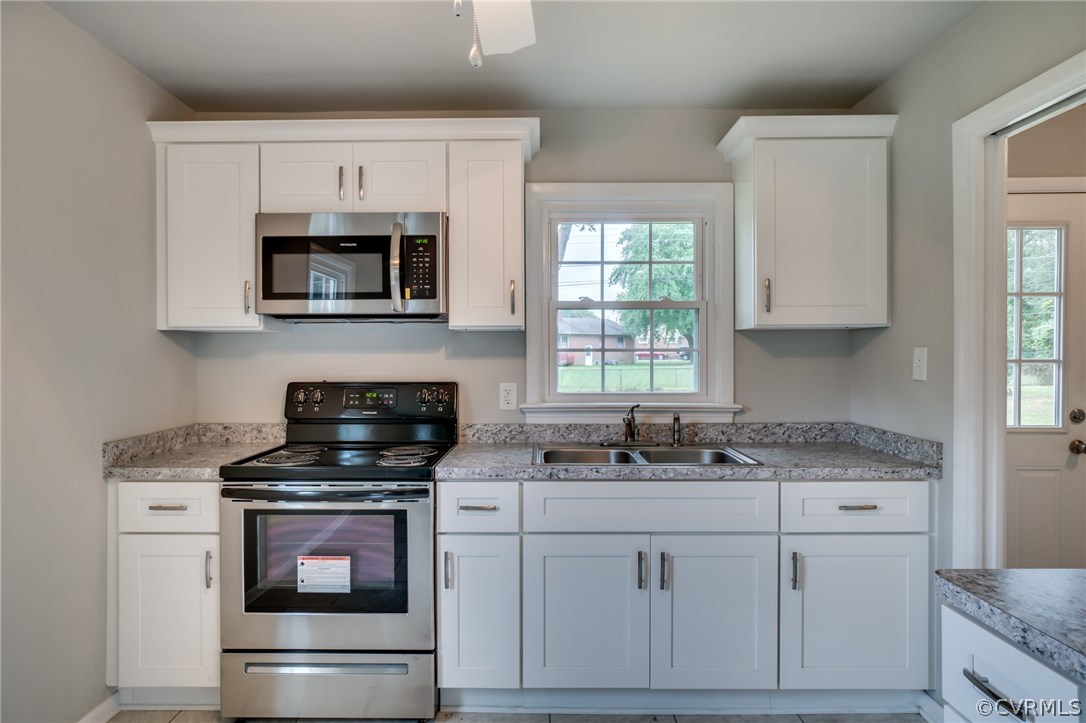 5525 Jahnke Road Richmond, VA 23225 - Photo 23 of 35 a kitchen with stainless steel appliances granite countertop a stove microwave and sink