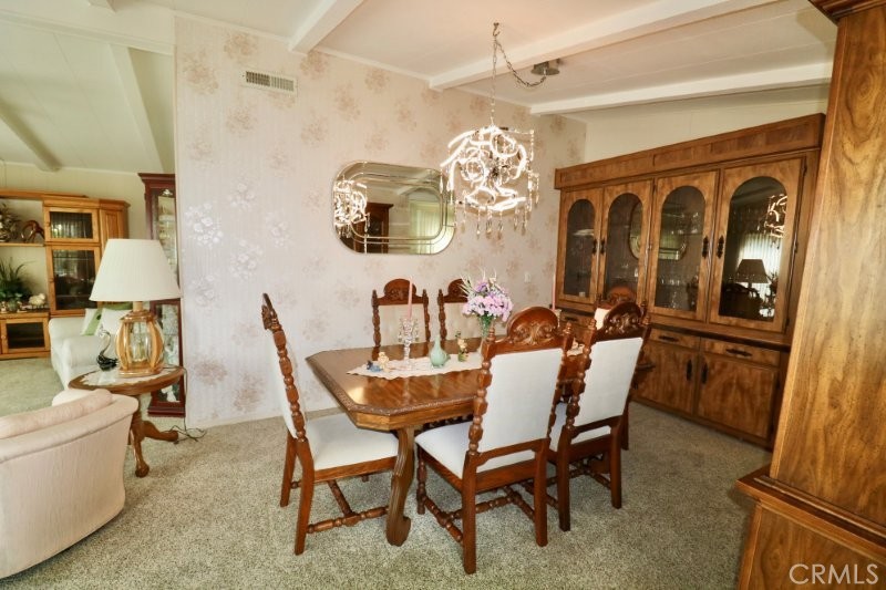 1346 Clear Lake Place, Unit 70 Brea, CA 92821 - Photo 26 of 53 a view of a dining room with furniture a chandelier and wooden floor