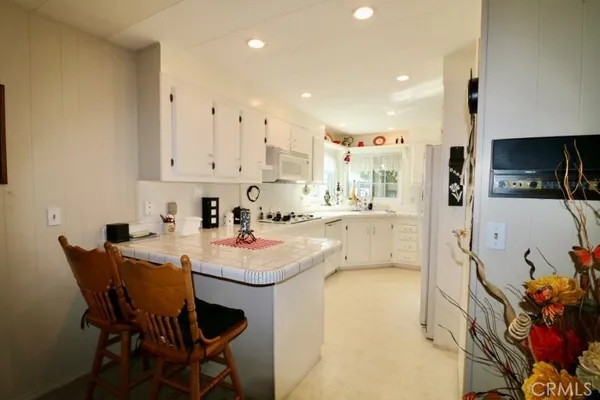 a kitchen with stainless steel appliances kitchen island granite countertop a sink and cabinets