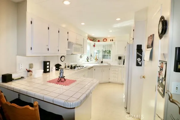 a kitchen with stainless steel appliances granite countertop a sink and cabinets