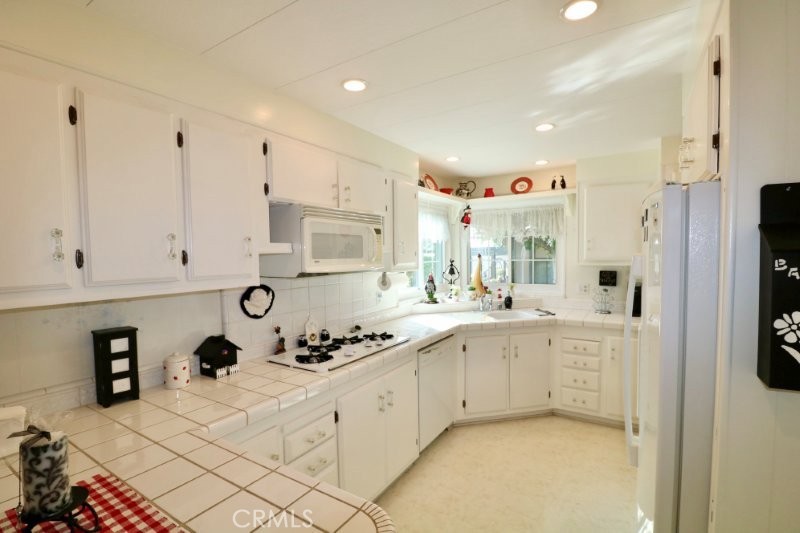 1346 Clear Lake Place, Unit 70 Brea, CA 92821 - Photo 30 of 53 a kitchen with stainless steel appliances granite countertop a sink and cabinets