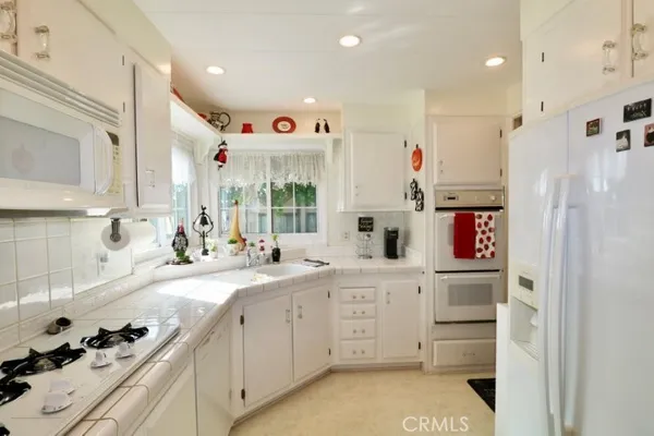 a kitchen with stainless steel appliances granite countertop a sink and dishwasher