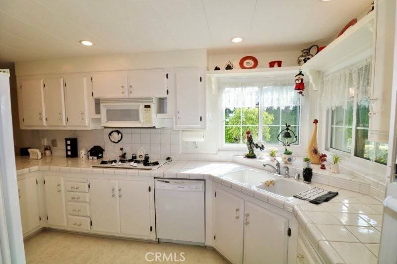 1346 Clear Lake Place, Unit 70 Brea, CA 92821 - Photo 33 of 53 a kitchen that has a lot of cabinets in it and white appliances