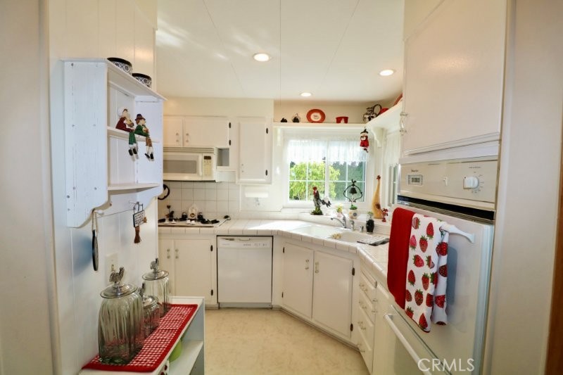 1346 Clear Lake Place, Unit 70 Brea, CA 92821 - Photo 34 of 53 a kitchen with stainless steel appliances granite countertop a sink and dishwasher
