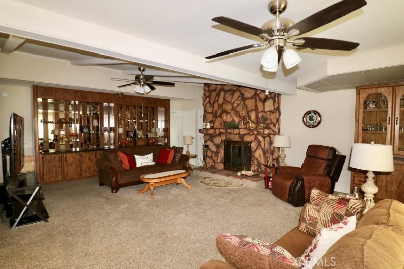 1346 Clear Lake Place, Unit 70 Brea, CA 92821 - Photo 37 of 53 a living room with furniture a chandelier and a flat screen tv