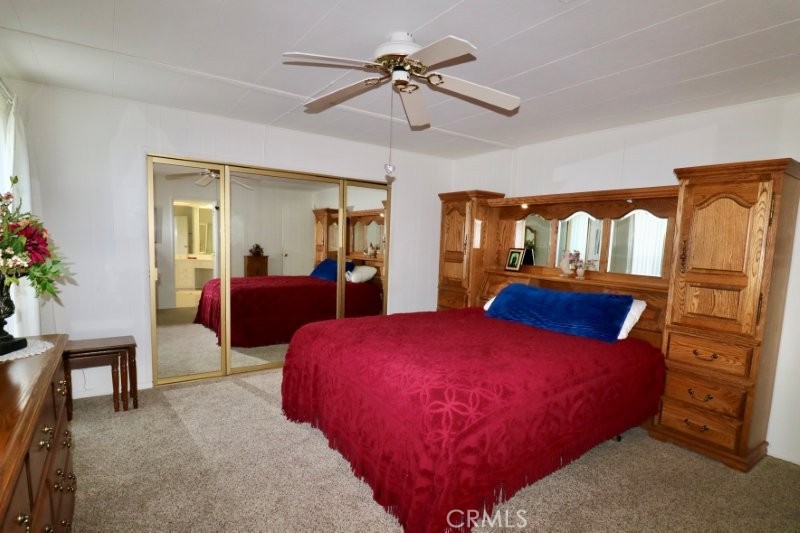 1346 Clear Lake Place, Unit 70 Brea, CA 92821 - Photo 41 of 53 a bedroom with a bed and a chandelier