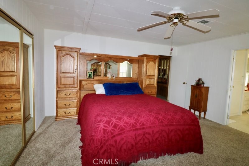 1346 Clear Lake Place, Unit 70 Brea, CA 92821 - Photo 42 of 53 a bedroom with a large bed and a chandelier