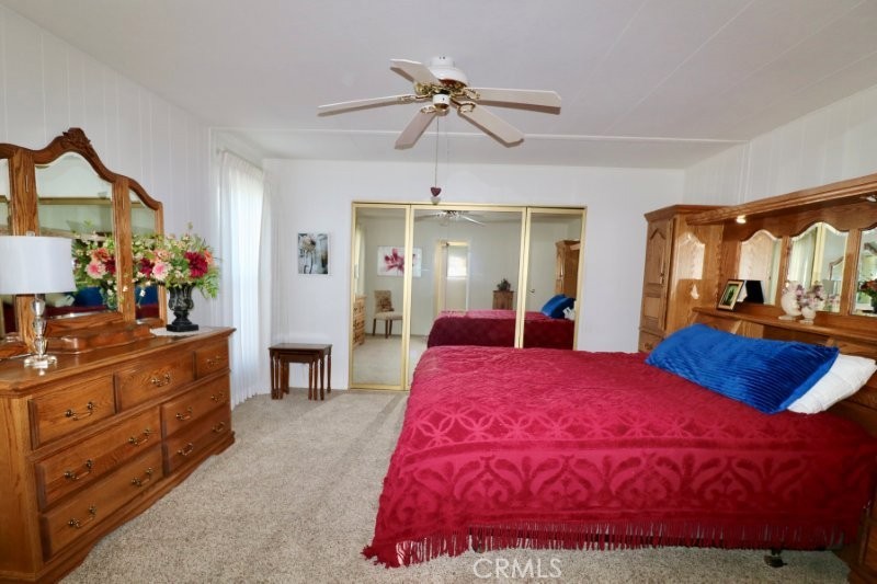 1346 Clear Lake Place, Unit 70 Brea, CA 92821 - Photo 43 of 53 a bed room with a bed mirror and a ceiling fan