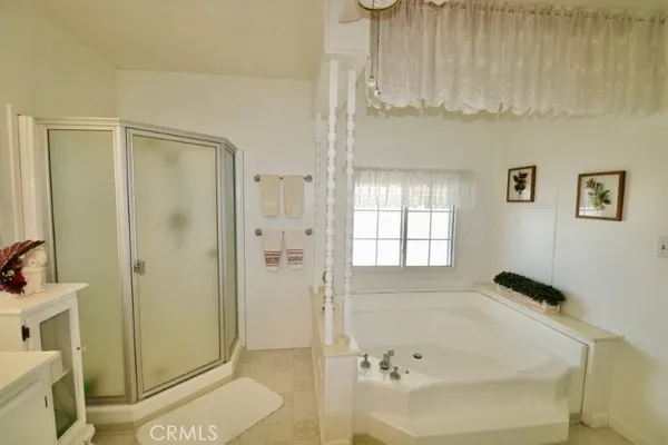 a bathroom with a double vanity sink mirror and a bathtub