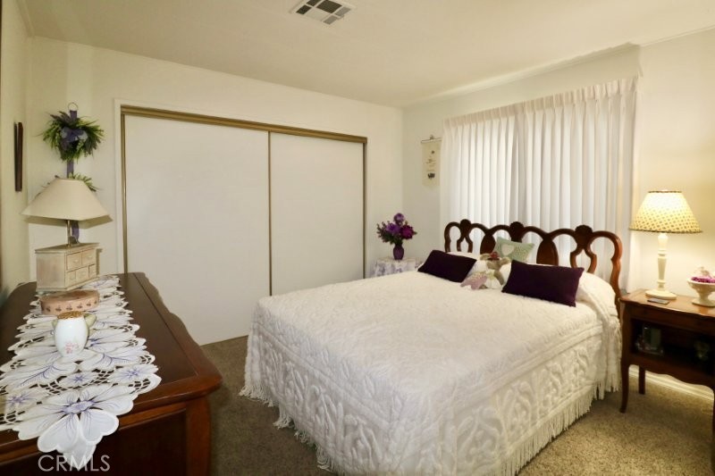 1346 Clear Lake Place, Unit 70 Brea, CA 92821 - Photo 48 of 53 a bedroom with a bed and wooden floor