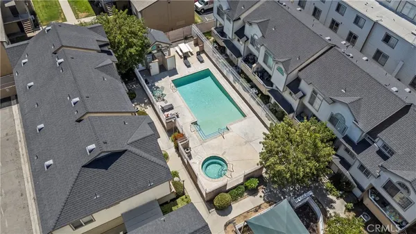 an aerial view of a house with garden space and building view