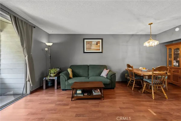 a living room with furniture a dining table and a fireplace