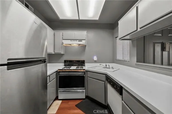 a kitchen with a stove and a refrigerator