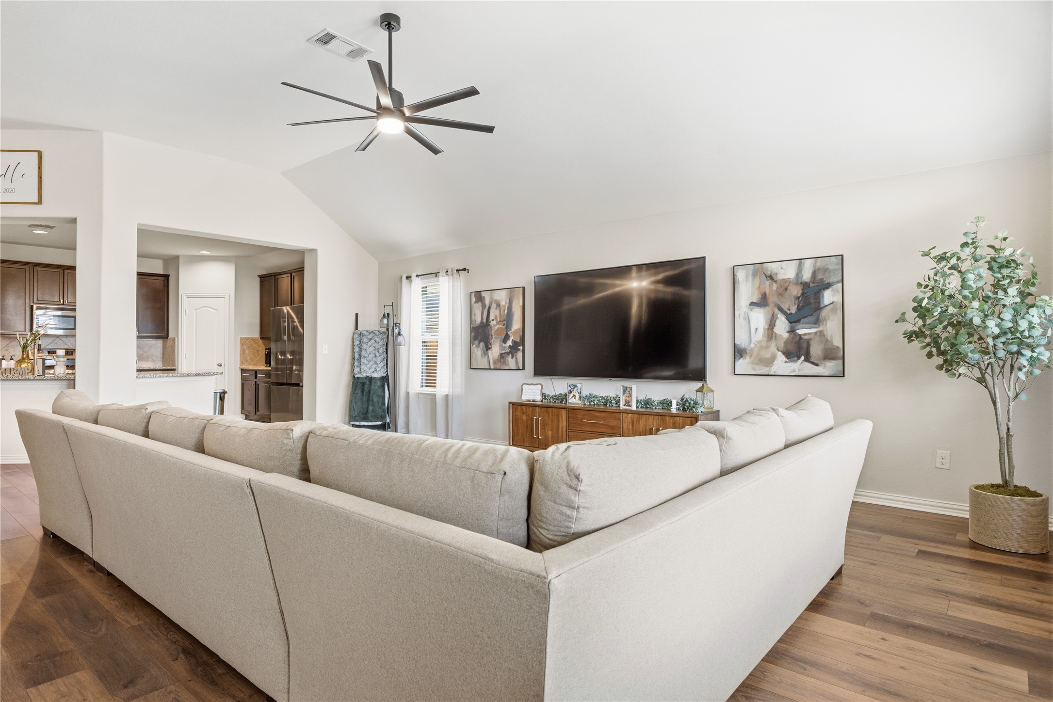 486 Pond View Pass Buda, TX 78610 - Photo 13 of 39 Spacious living area featuring vaulted ceilings, wood-finish flooring, a modern ceiling fan, and recessed lighting