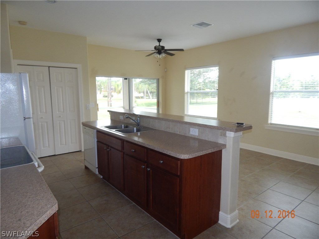 12780 River Road Fort Myers, FL 33905 - Photo 19 of 24 a kitchen with granite countertop a sink and a stove