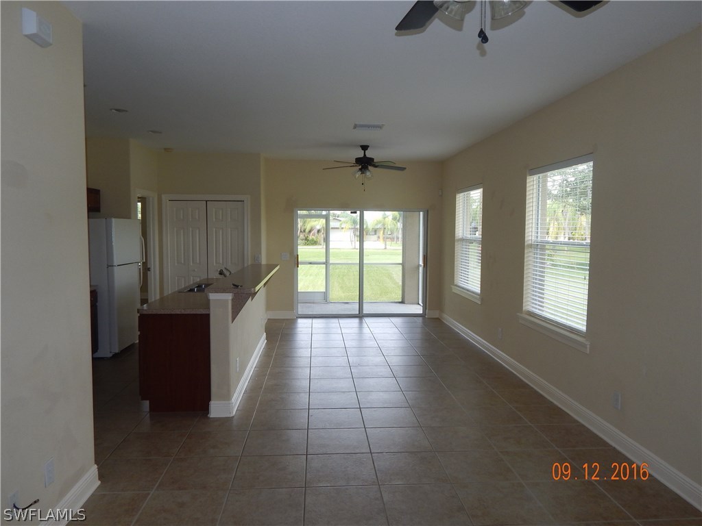12780 River Road Fort Myers, FL 33905 - Photo 3 of 24 a large living room with a window and a chandelier