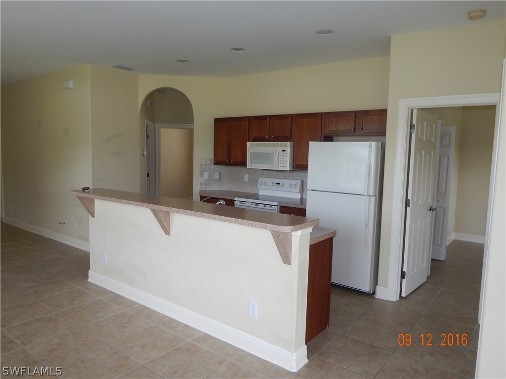 12780 River Road Fort Myers, FL 33905 - Photo 7 of 24 a room with refrigerator and a more cabinets