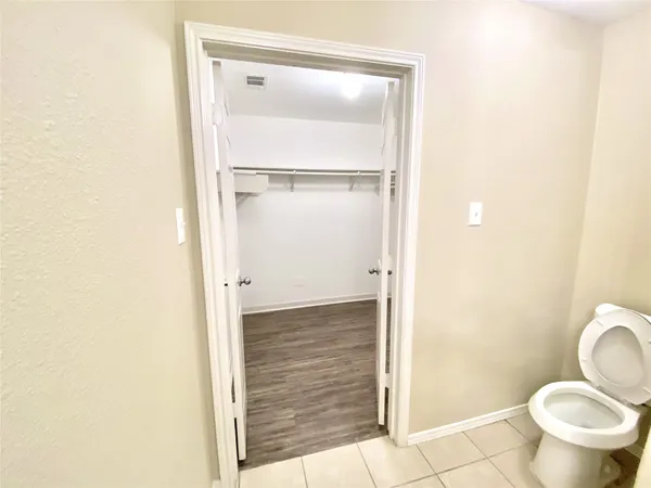 a bathroom with a granite countertop toilet and a sink