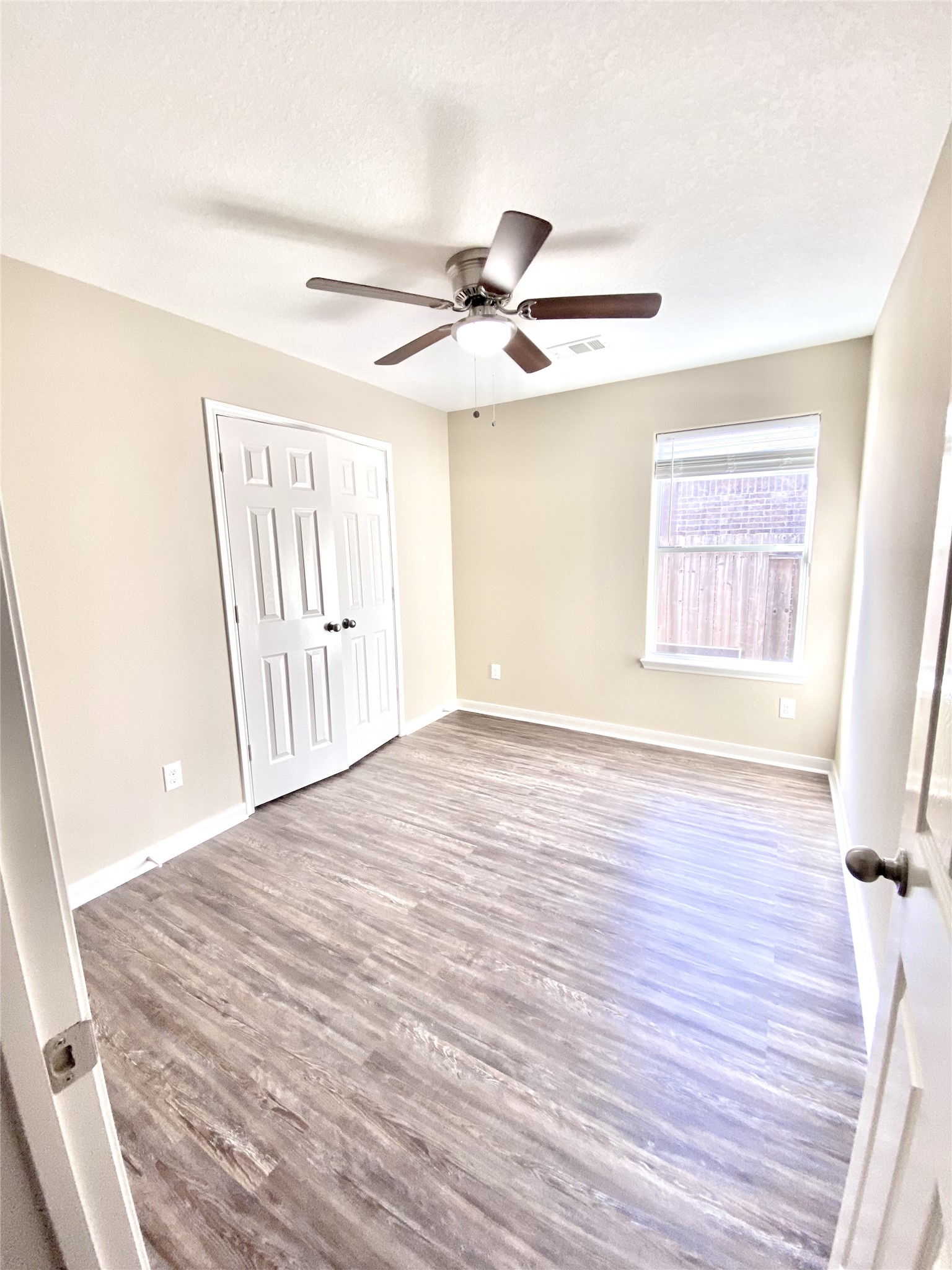 28922 San Bernard River Loop Spring, TX 77386 - Photo 15 of 31 a view of an empty room with wooden floor and a window