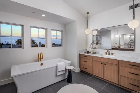 a spacious bathroom with a double vanity sink mirror and window
