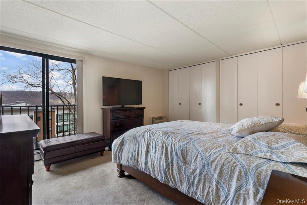 1116 Warburton Avenue, Unit 2A Yonkers, NY 10701 - Photo 12 of 19 a bedroom with a bed and a large window