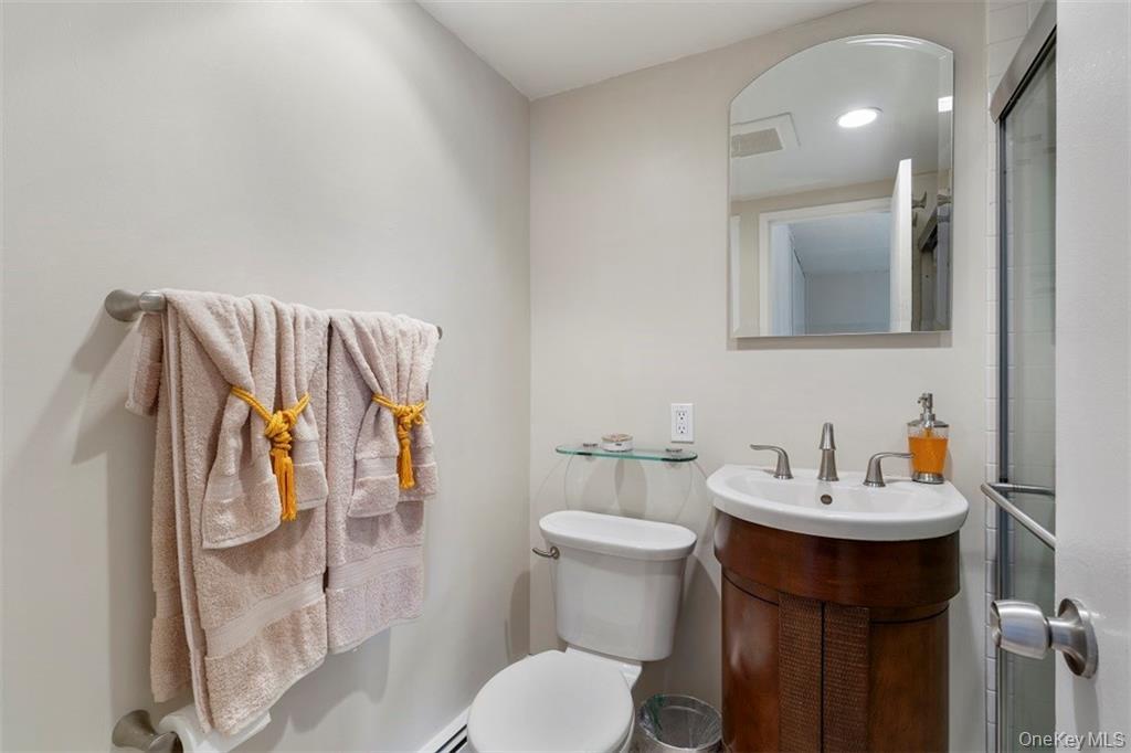 1116 Warburton Avenue, Unit 2A Yonkers, NY 10701 - Photo 14 of 19 a bathroom with a sink mirror and toilet