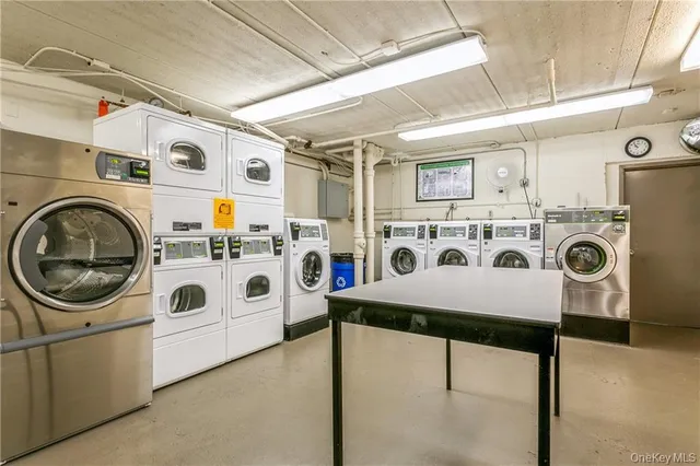 a utility room with stainless steel appliances washer and dryer