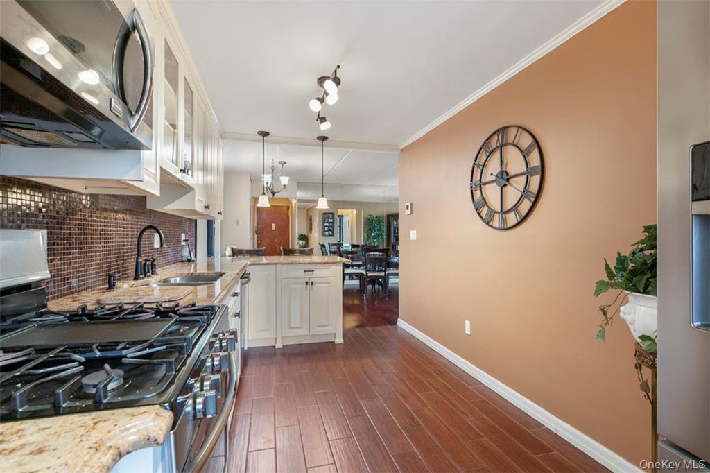 1116 Warburton Avenue, Unit 2A Yonkers, NY 10701 - Photo 8 of 19 a kitchen with a stove and a wooden floor