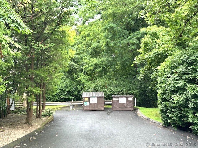 500 Prospect Street, Unit 1E New Haven, CT 06511 - Photo 17 of 18 a wooden bench sitting in the middle of a forest
