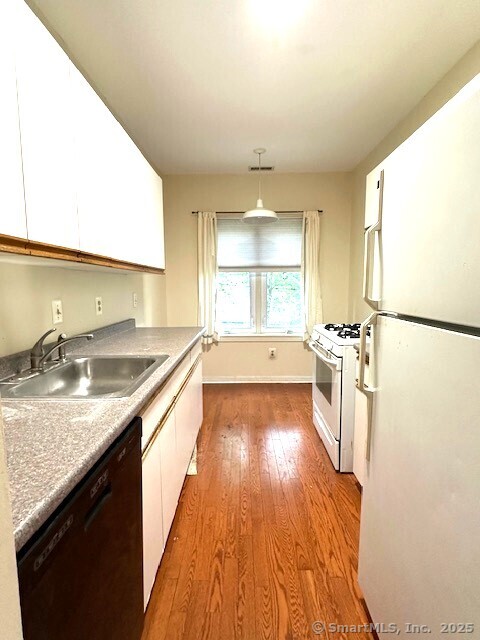500 Prospect Street, Unit 1E New Haven, CT 06511 - Photo 6 of 18 a large kitchen with stainless steel appliances granite countertop a sink and a stove