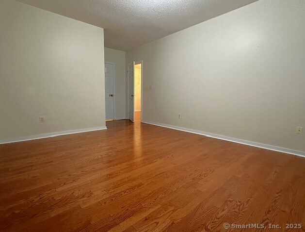 500 Prospect Street, Unit 1E New Haven, CT 06511 - Photo 8 of 18 an empty room with wooden floor and windows