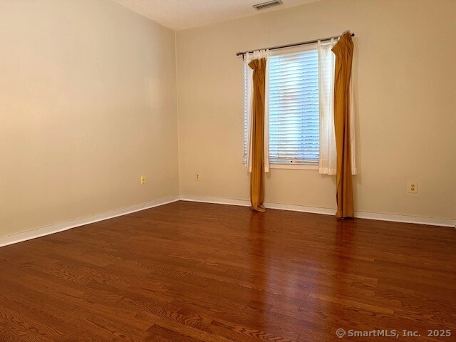 500 Prospect Street, Unit 1E New Haven, CT 06511 - Photo 9 of 18 a view of an empty room with wooden floor and a window