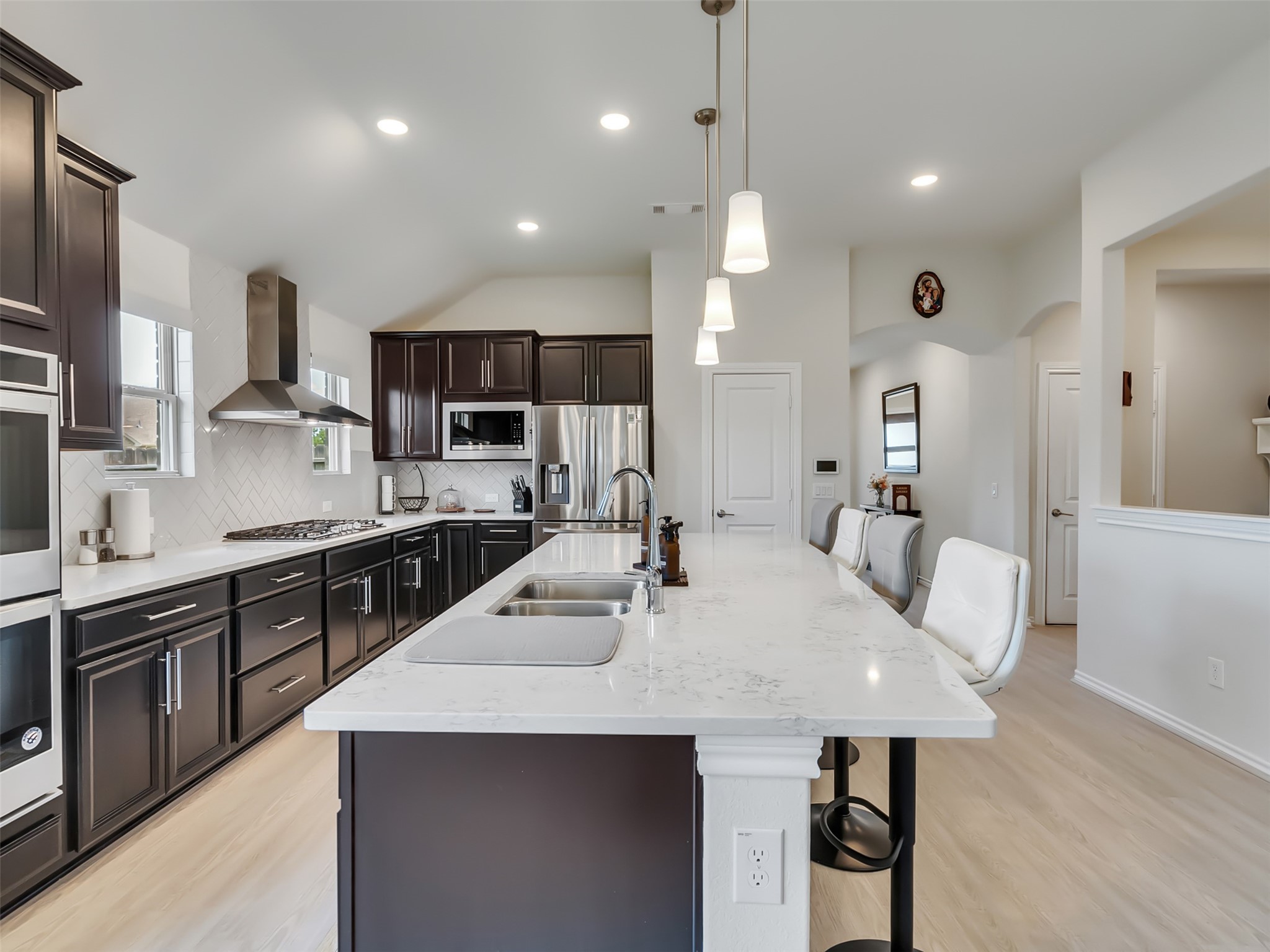 27997 Lone Hollow Lane Spring, TX 77386 - Photo 23 of 45 a large kitchen with kitchen island a sink a counter space and stainless steel appliances