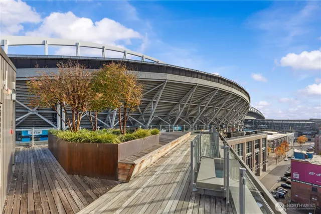 a view of a balcony with wooden floor and city view