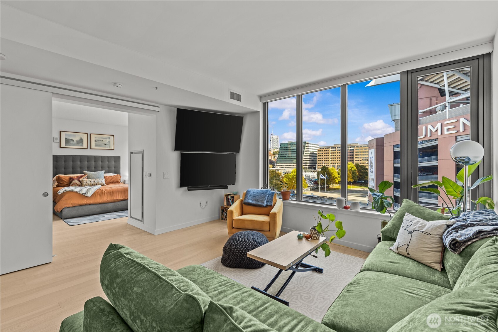 590 1st Avenue South, Unit 715 Seattle, WA 98104 - Photo 9 of 39 a living room with furniture and a flat screen tv