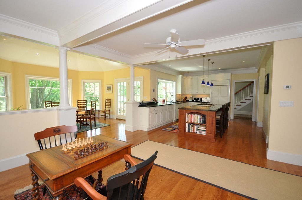 1643 Monument Street Concord, MA 01742 - Photo 12 of 27 a dining room with furniture a floor to ceiling window and wooden floor